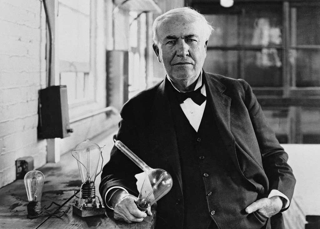 Thomas Alva Edison with the light bulb he invented