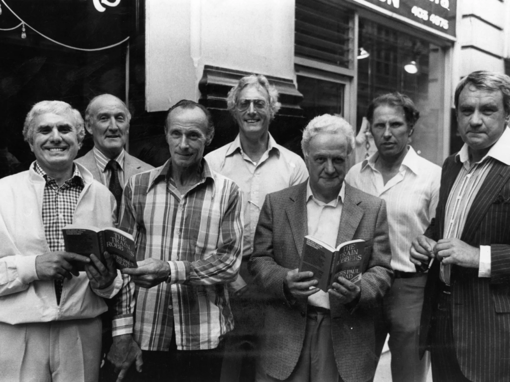 The Great Train Robbers (from left): Buster Edwards, Tom Wisbey, Jim White, Bruce Reynolds, Roger Cordrey, Charlie Wilson and Jim Hussey, with copies of their book The Train Robbers in 1979.

