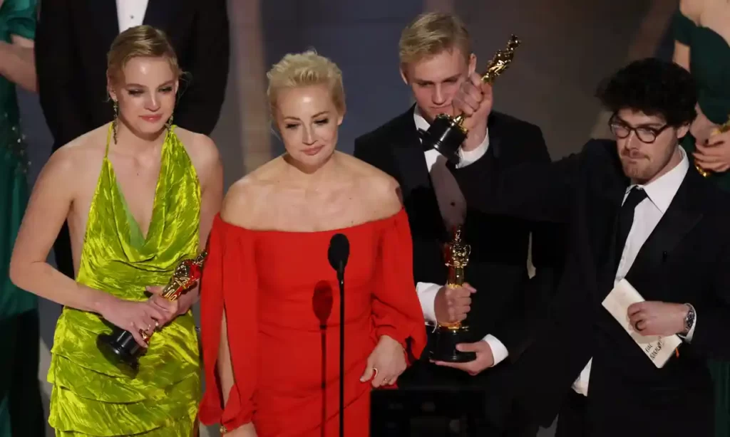Yulia Navalnya (second left), the wife of jailed dissident Alexei Navalny, speaks next to her daughter Daria (far left) and director Daniel Roher (far right) after Navalny won the Academy Award for best feature documentary. " during the Oscars show in Hollywood, Los Angeles, California, U.S., March 12, 2023.   Photograph: Carlos Barría/Reuters